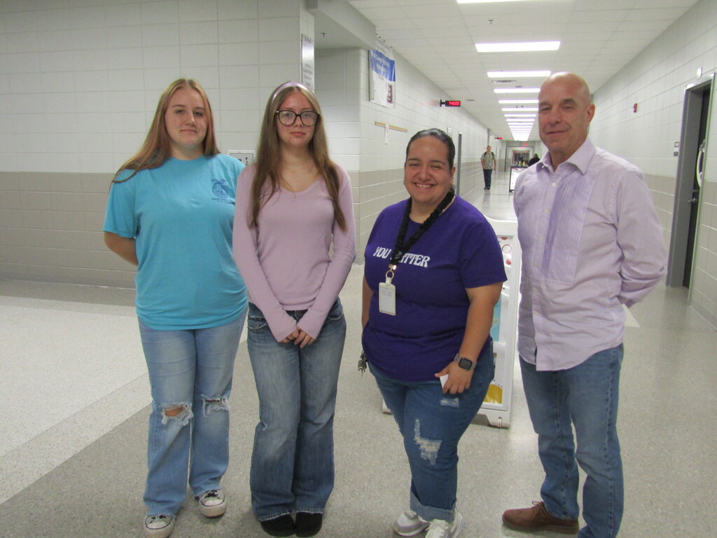 faculty and students wearing purple and teal