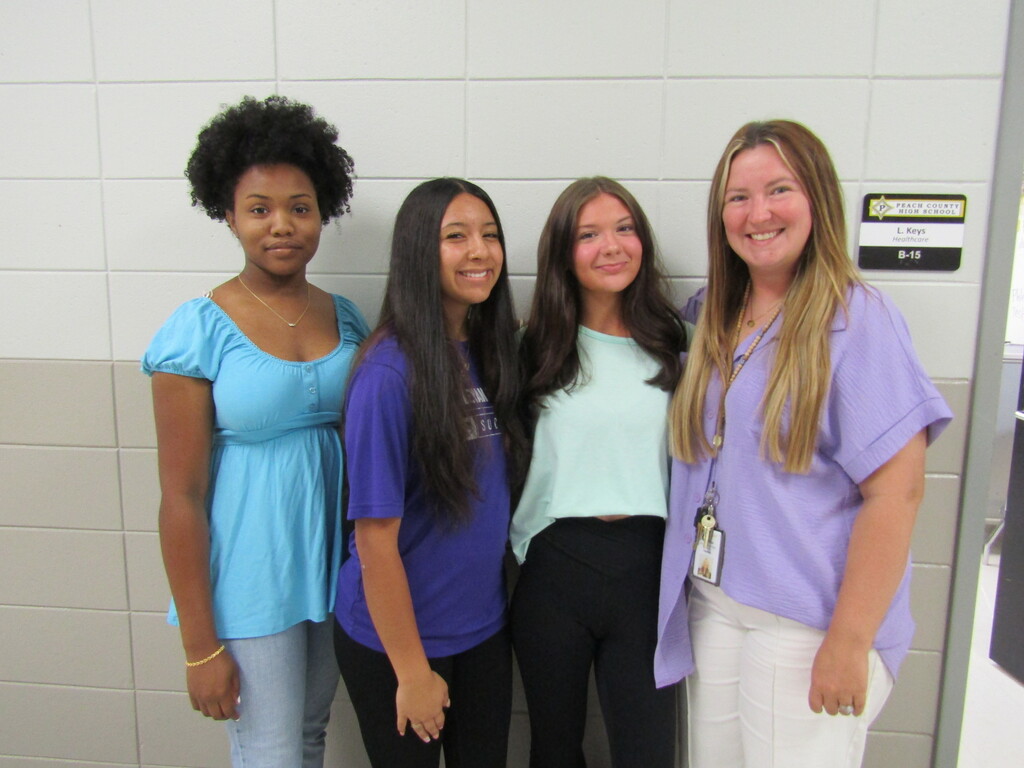 faculty and students wearing purple and teal