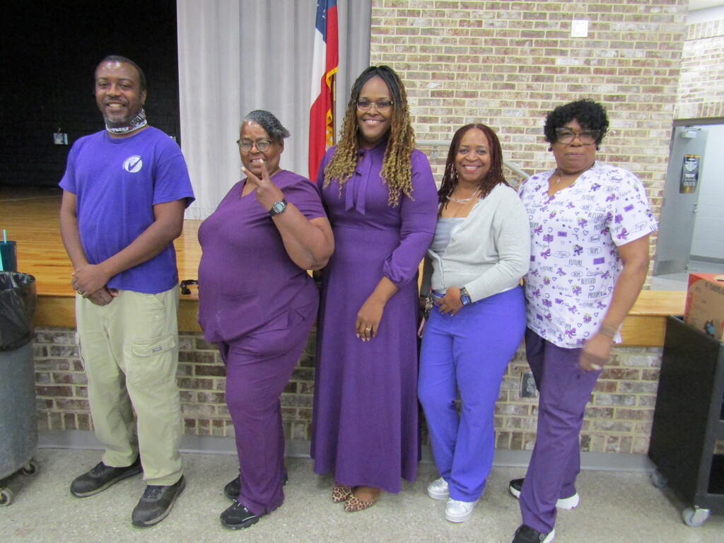 faculty and students wearing purple and teal