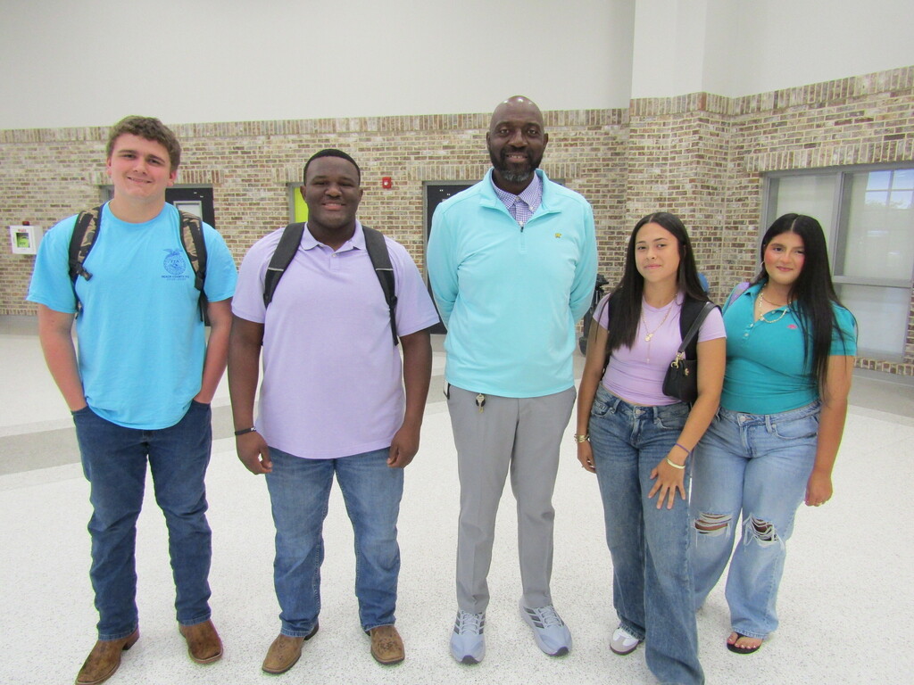 faculty and students wearing purple and teal
