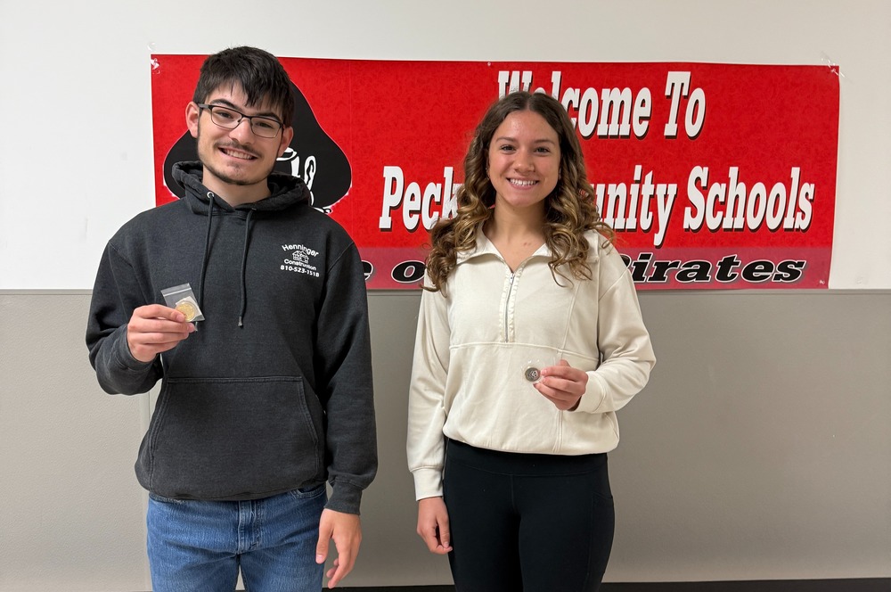 April Varsity Athlete of the Month holding medals