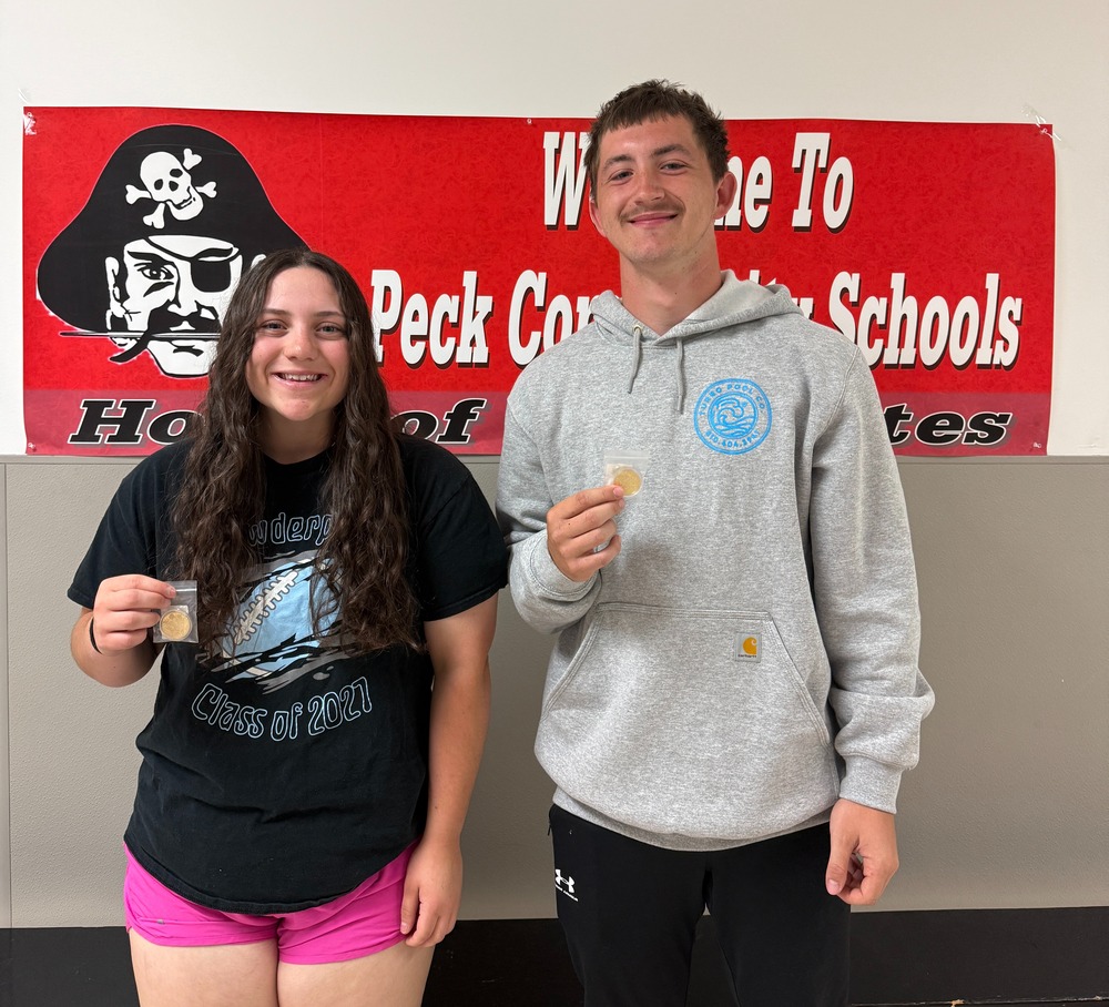 Pictured are two varsity athletes of the month, chosen by the coaches, displaying their medals.