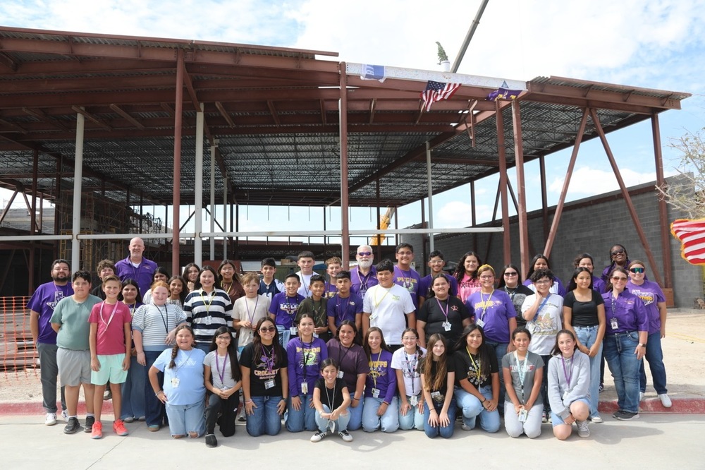CMS Students and staff posing with final beam of the new crockett middle school
