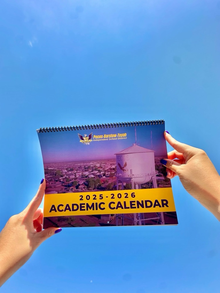 2025-2026 academic wall calendar being held up against blue sky