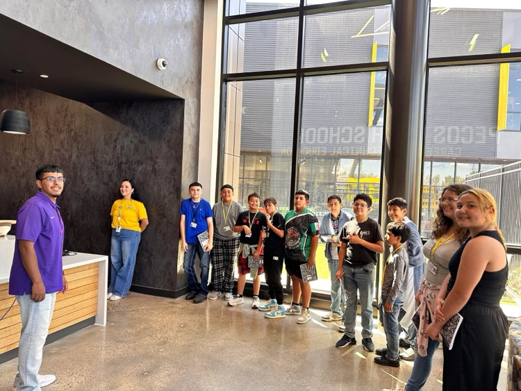Students and staff standing in the CTE lobby smiling.