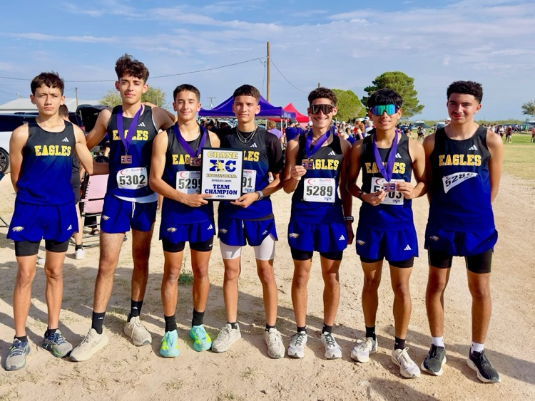 Pecos High School Eagles pictured as a team display their team champion plaque from their Cross Country meet in Crane.