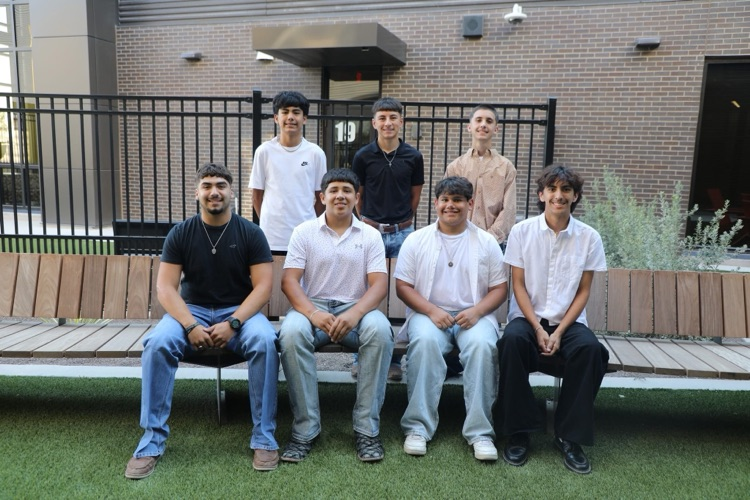2025 Homecoming Court Boys. Front row boy are dressed casually with jeans and causal tops and collared shirts. Back row boys are standing behind them, with casual and collared shirts. 