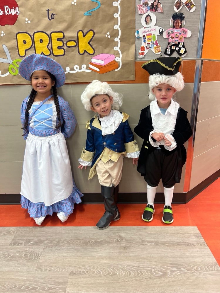 Three students aligned side by side, dressing up as the Founding Fathers with their white wigs.