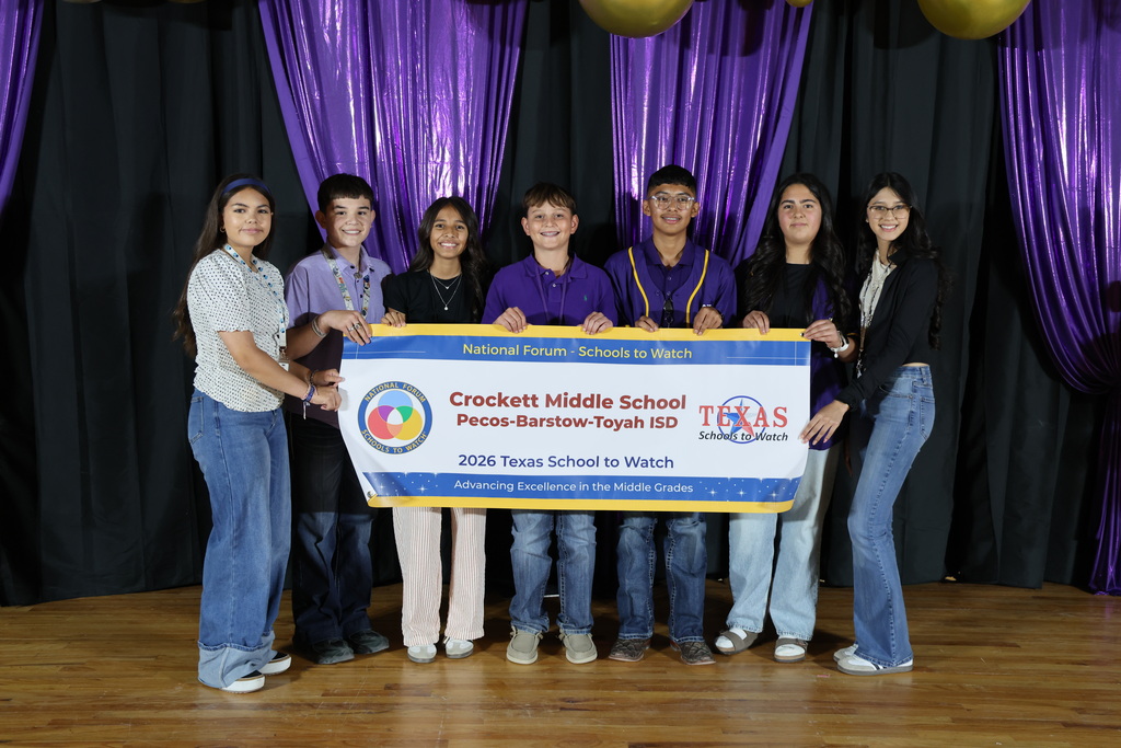 A group of 7 students holding a sign for Crockett Middle School's Schools to Watch
