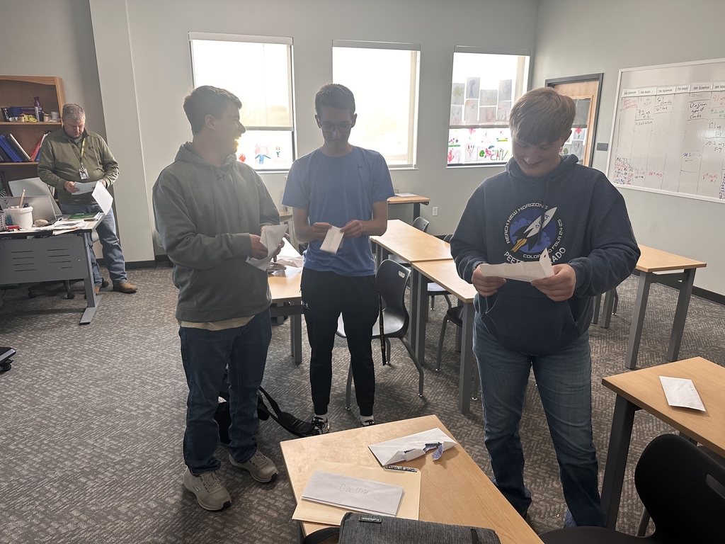Senior boys reading a letter to themselves