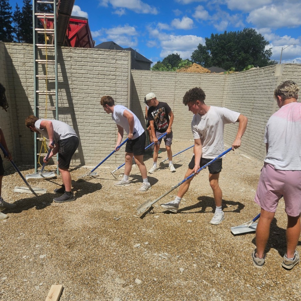 Construction trades spreading rock