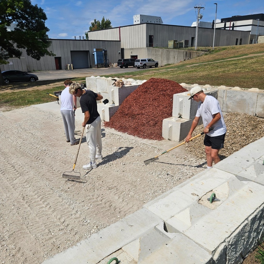 construction students leveling gravel