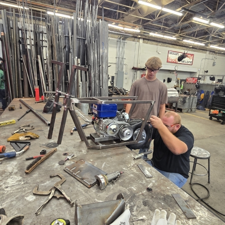 Mr Thomas giving Shea a few pointers on his custom frame he designed and building in manufacturing 2 class