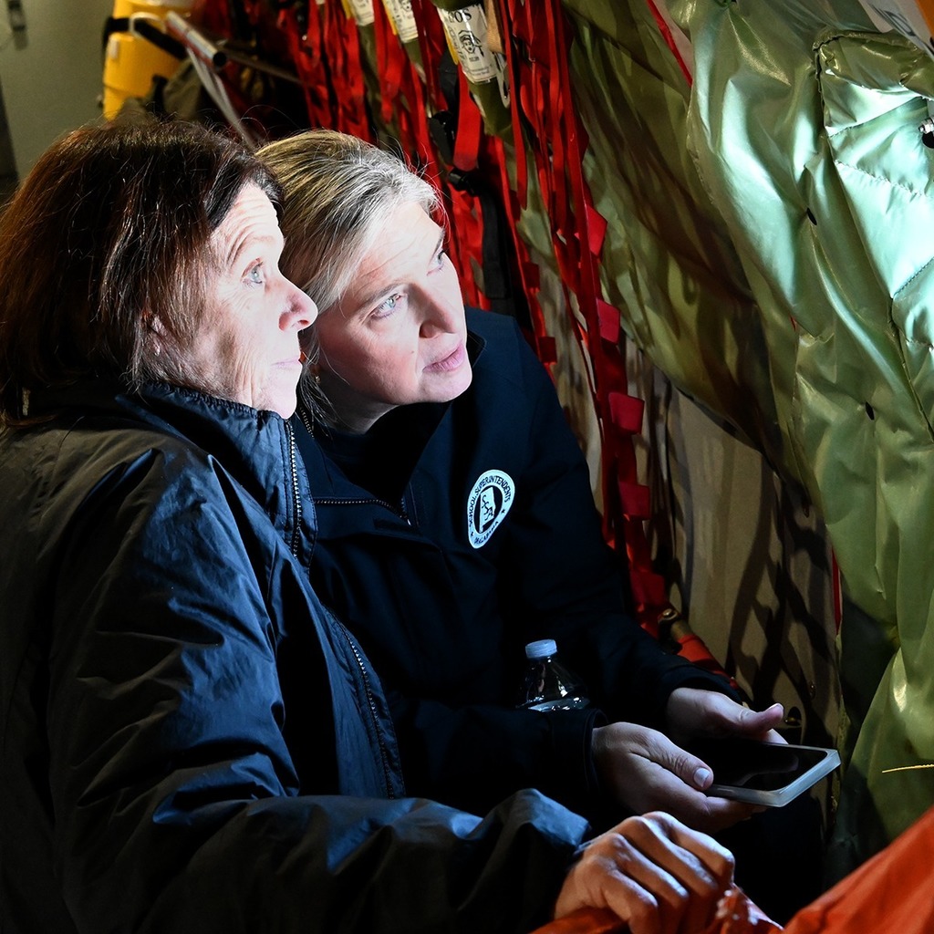 Women looking out window in plane
