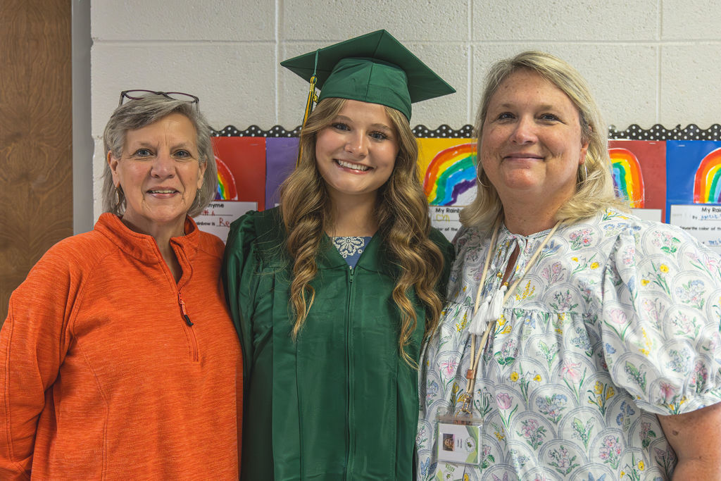 Teachers and senior student smiling 