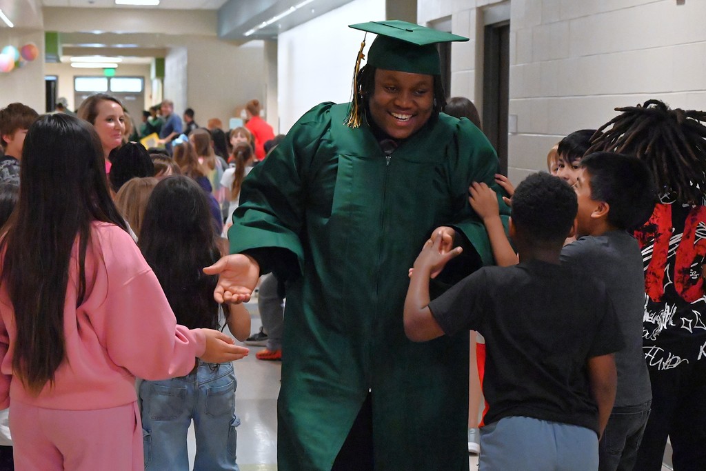 Smiling senior walking through school hallway 