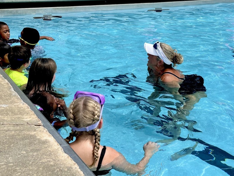 Students with YMCA instructor in the pool