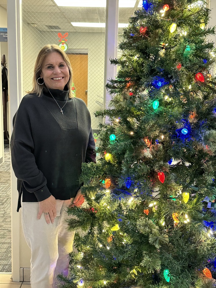 Ms Betty next to the Christmas Tree