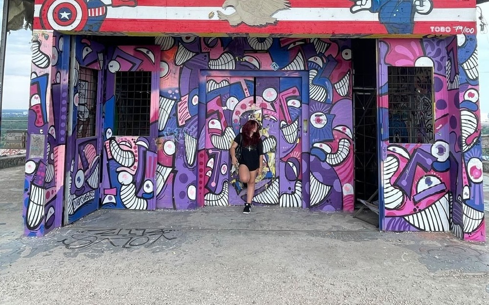 Image of Markus in front of painted wall mural