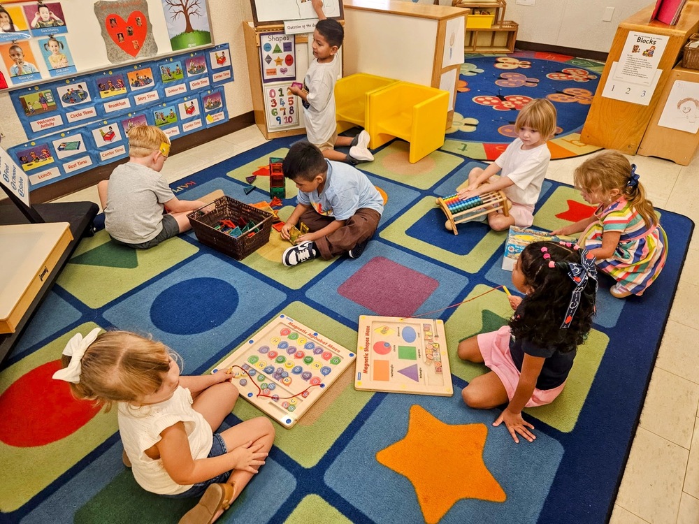 Students playing together in the classroom.