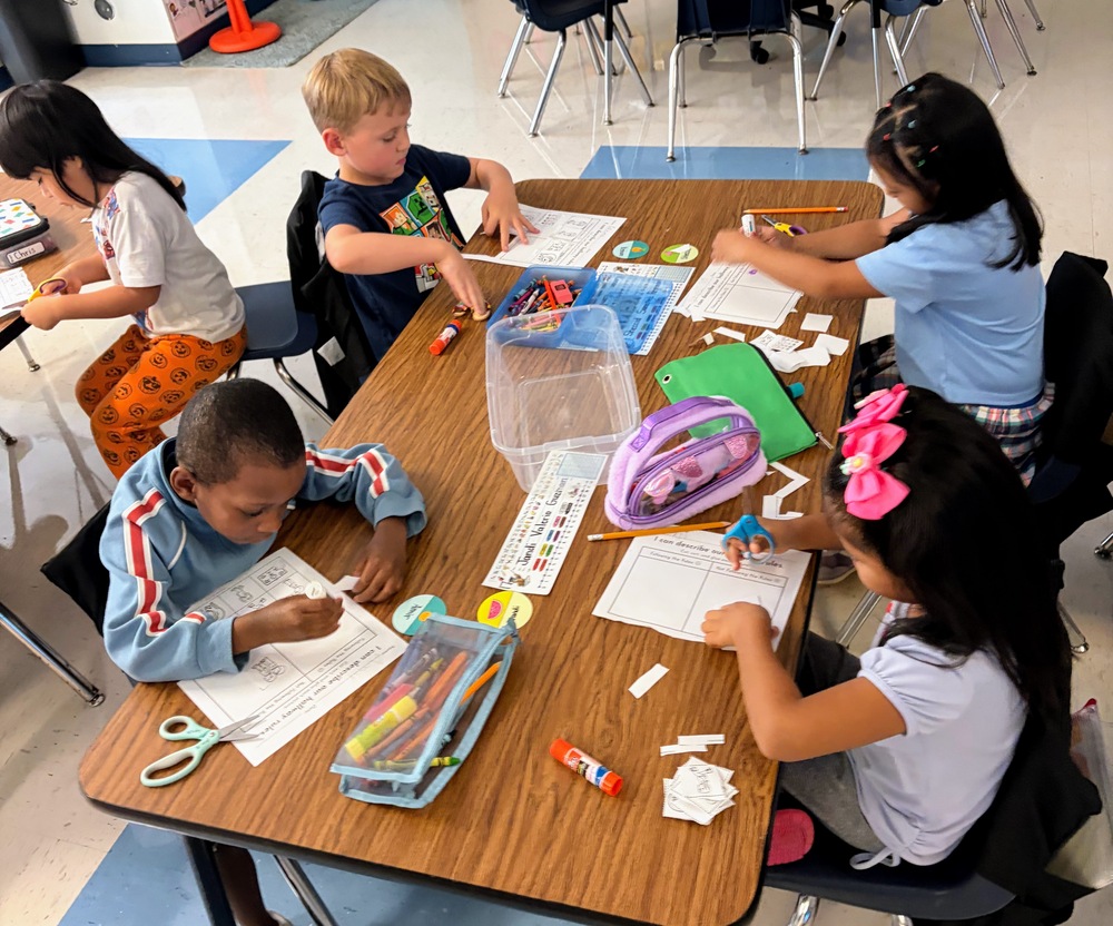 Kindergarten students working at desk.