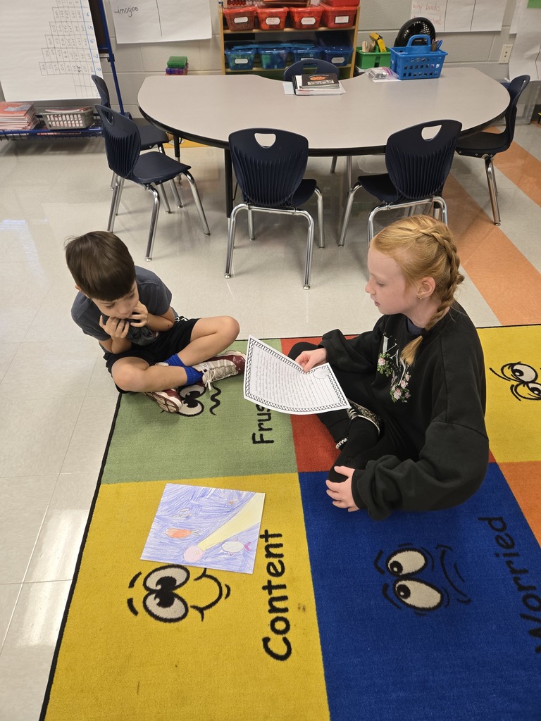 3rd graders reading to 1st graders