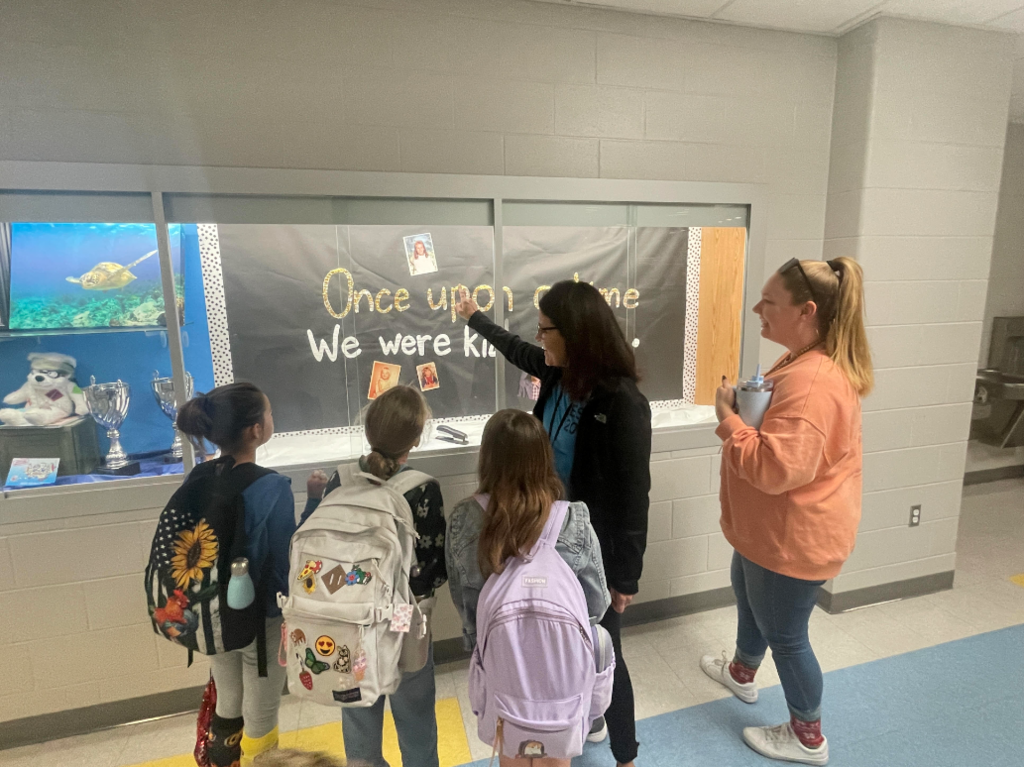 students and staff talking in the hallway
