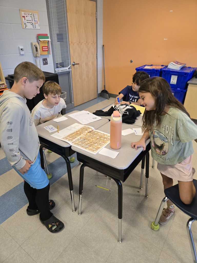 3rd grade students working on a sequencing activity at their desks