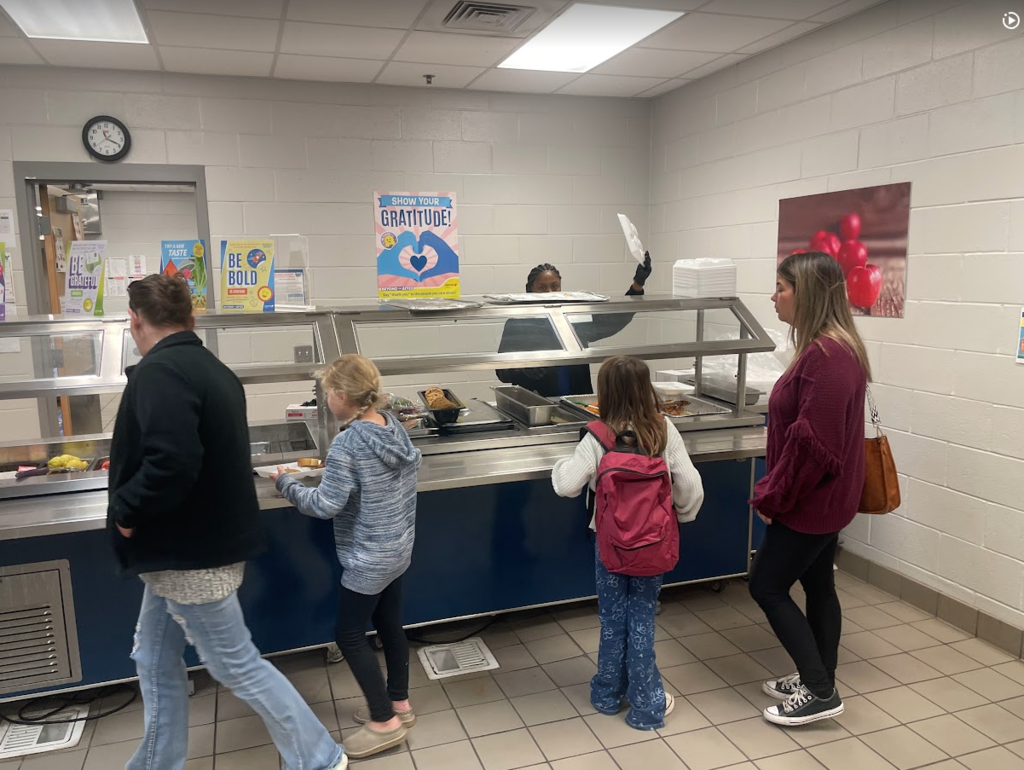 families going through the lunch line