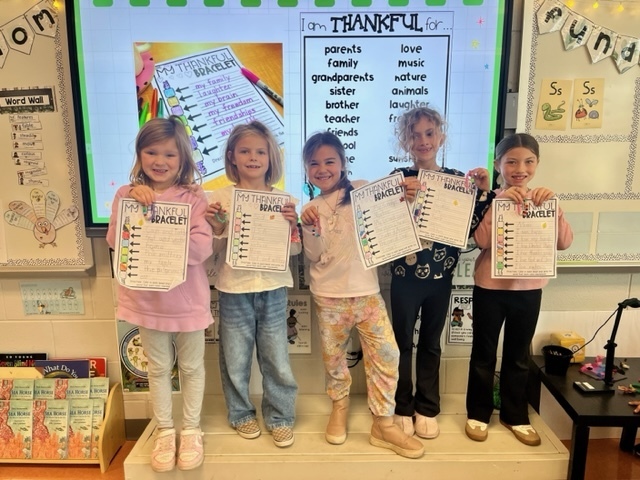 1st graders holding up work