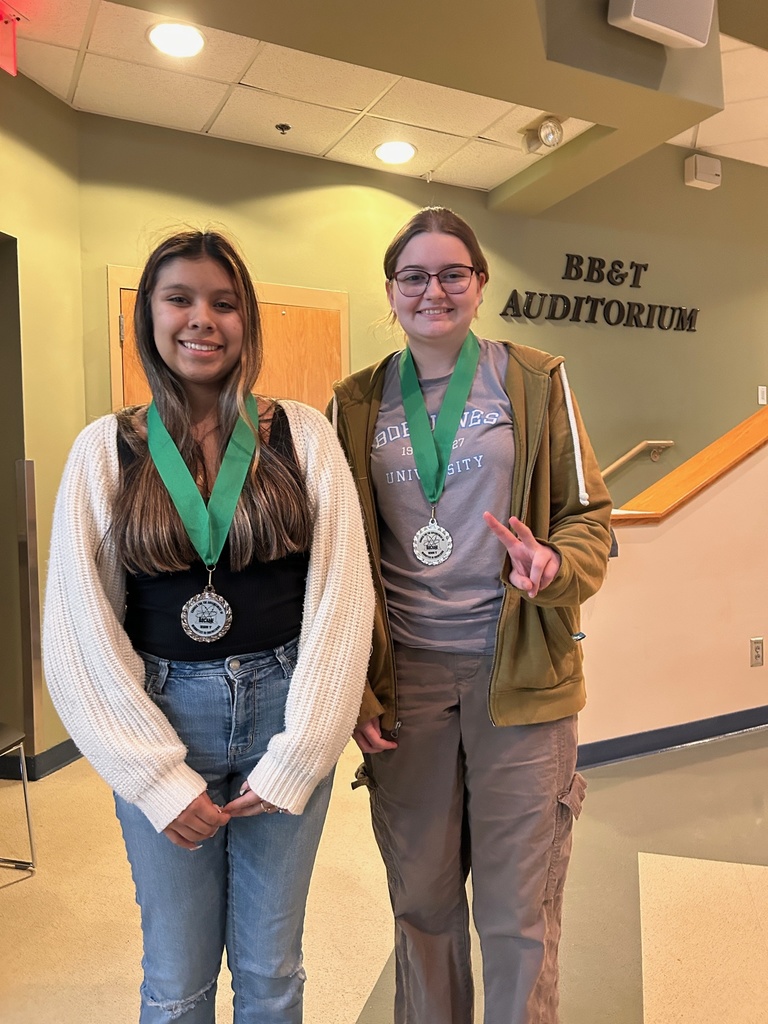 2 students pose with their medals
