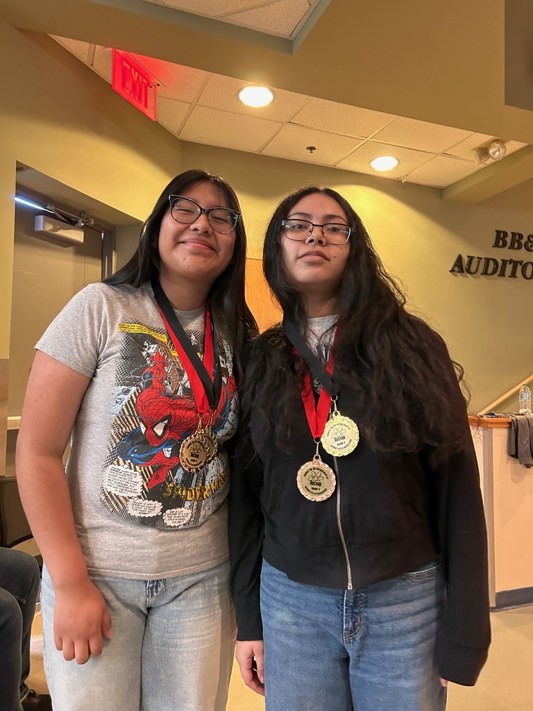 2 students pose with their medals