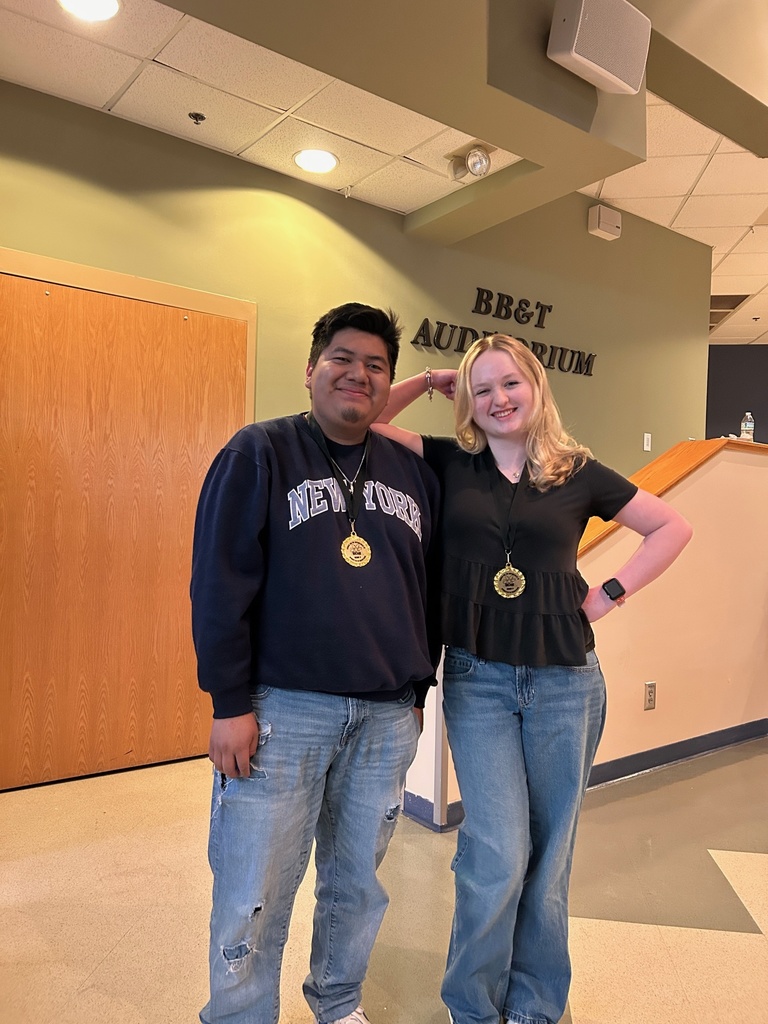 2 students pose with their medals