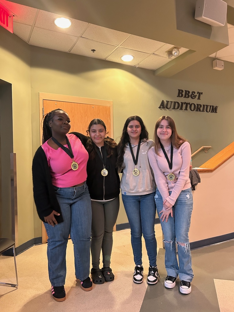4 students pose with their medals