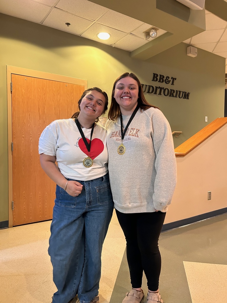 2 students pose with their medals