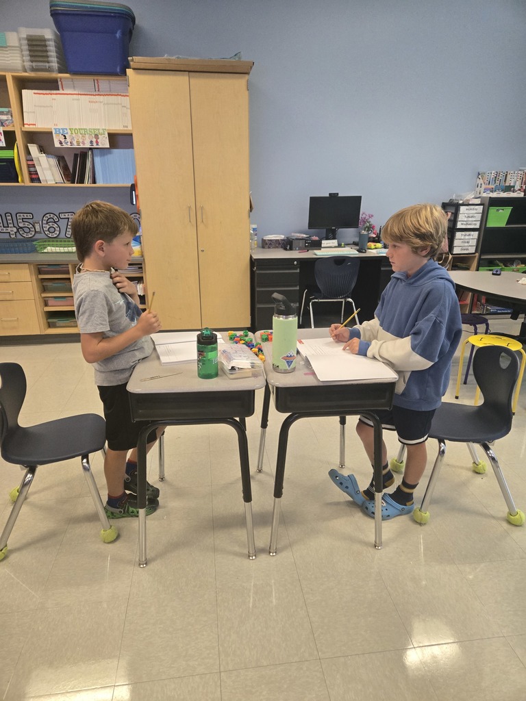 3rd graders working in partners with math manipulatives 