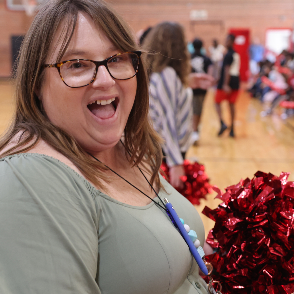 staff member holding pom pom