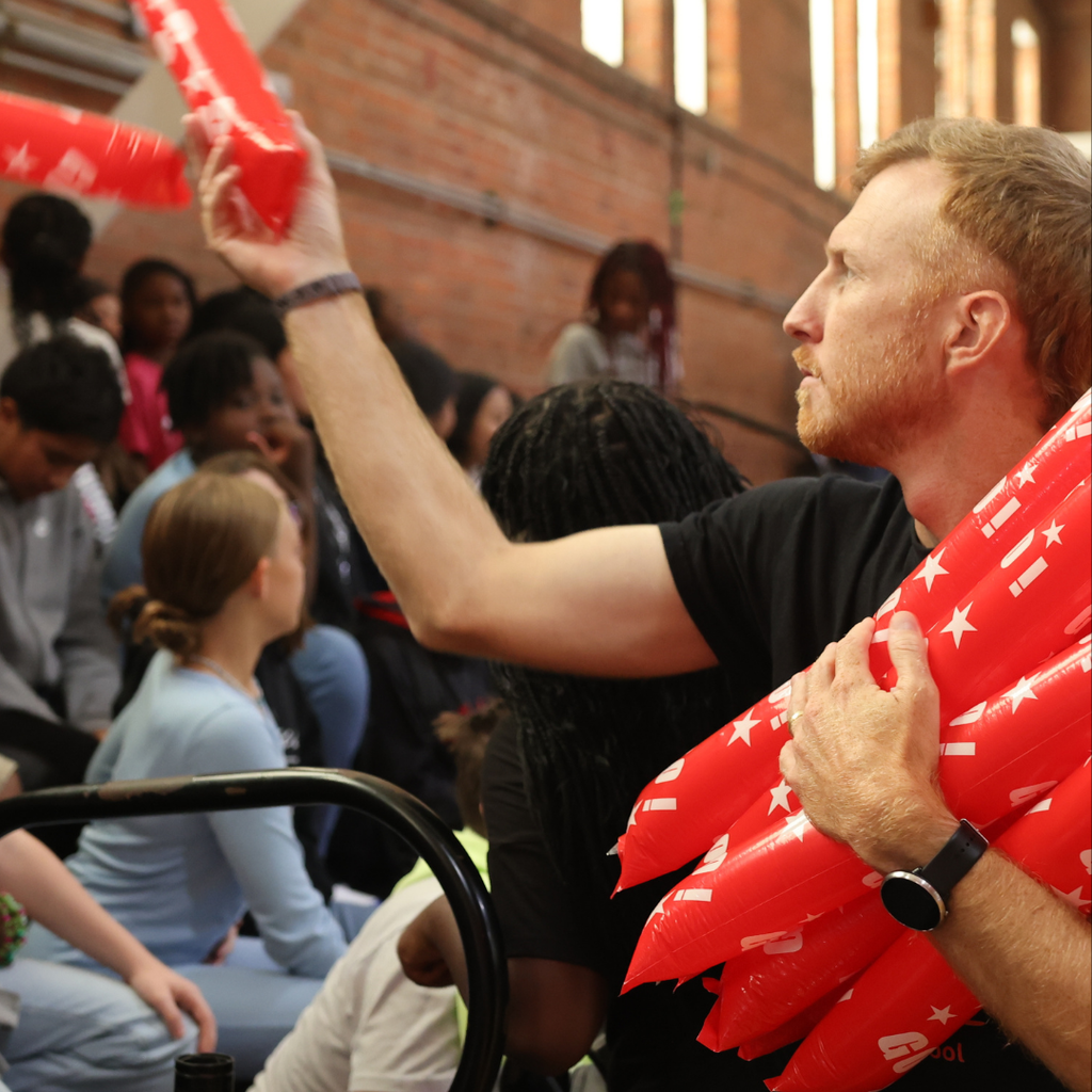 staff member handing out pep rally favors