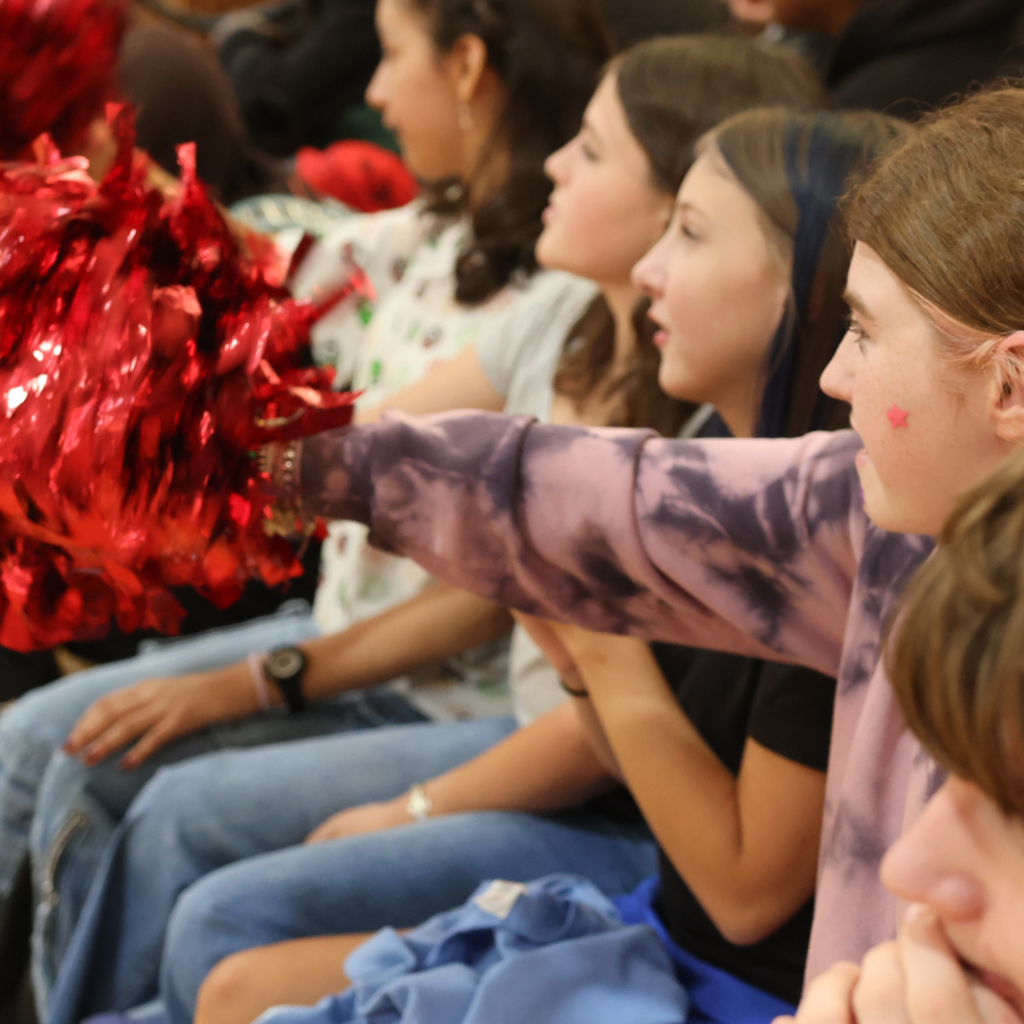 students cheering with pom pom