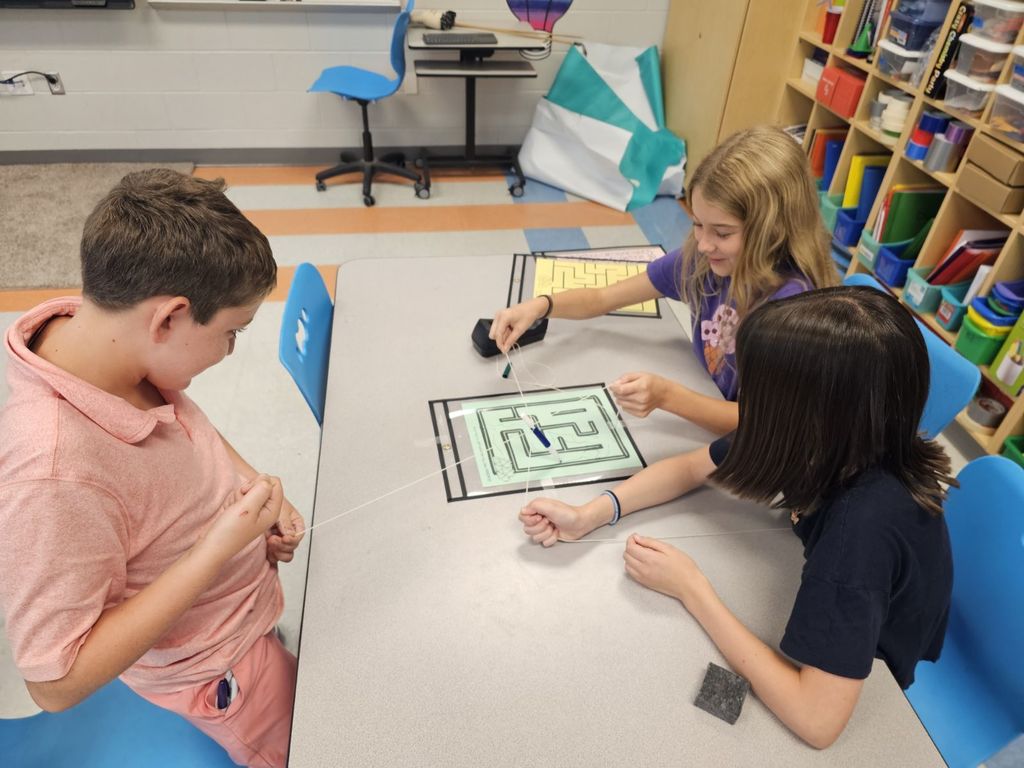 4th and 5th Grade are working on TEAMWORK as they try to help the elephants get to the fruit on a maze. This activity is based on the book That Fruit is Mine and students had to use communication and collaboration to navigate the pens by string on the maze.