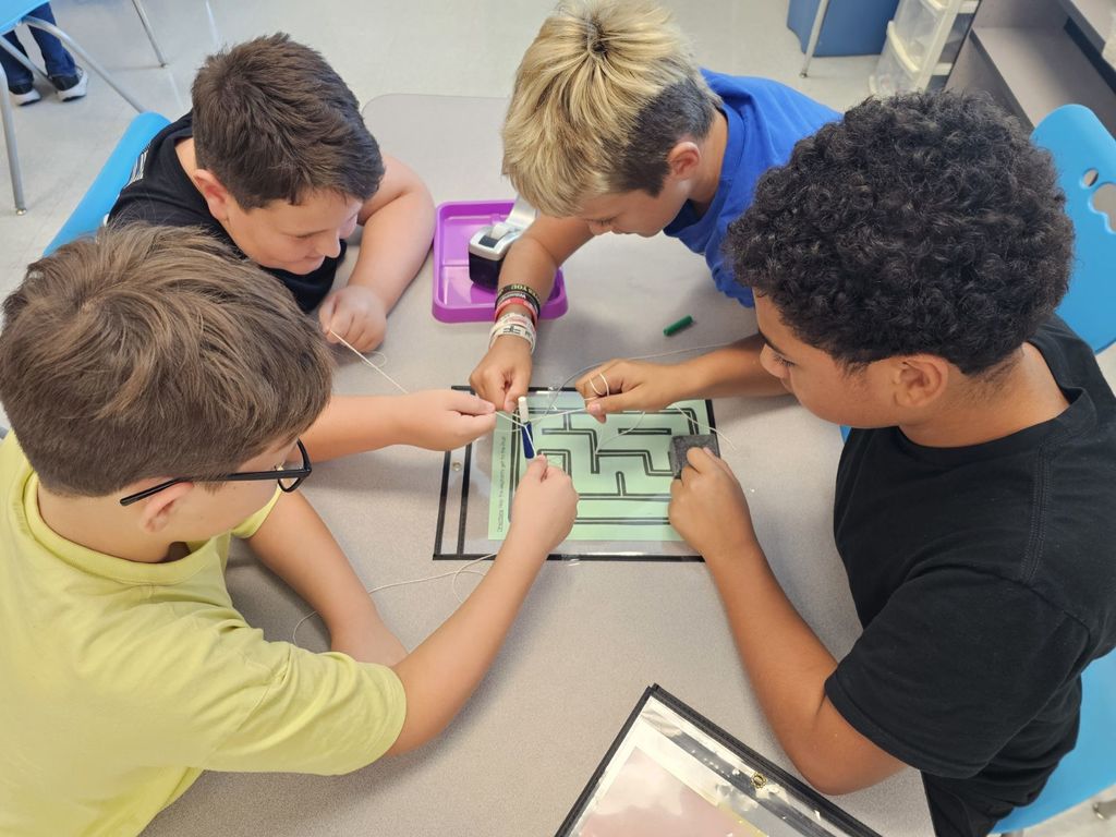 4th and 5th Grade are working on TEAMWORK as they try to help the elephants get to the fruit on a maze. This activity is based on the book That Fruit is Mine and students had to use communication and collaboration to navigate the pens by string on the maze.