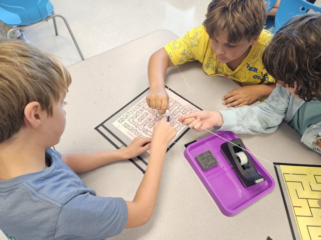 4th and 5th Grade are working on TEAMWORK as they try to help the elephants get to the fruit on a maze. This activity is based on the book That Fruit is Mine and students had to use communication and collaboration to navigate the pens by string on the maze.