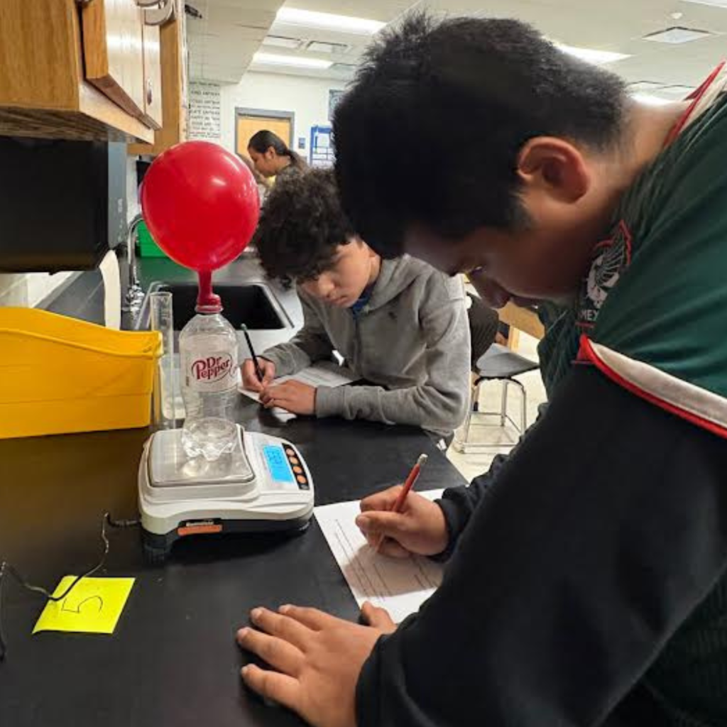 students conducting a science lab in the classroom