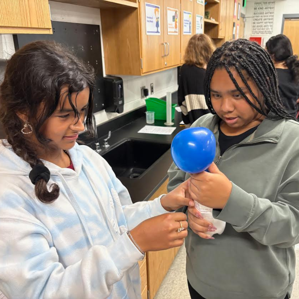 students conducting a science lab in the classroom