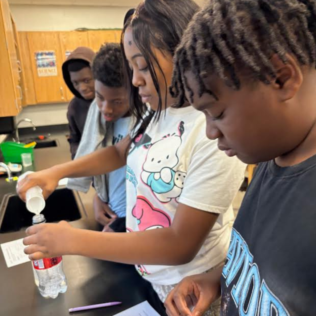 students conducting a science lab in the classroom