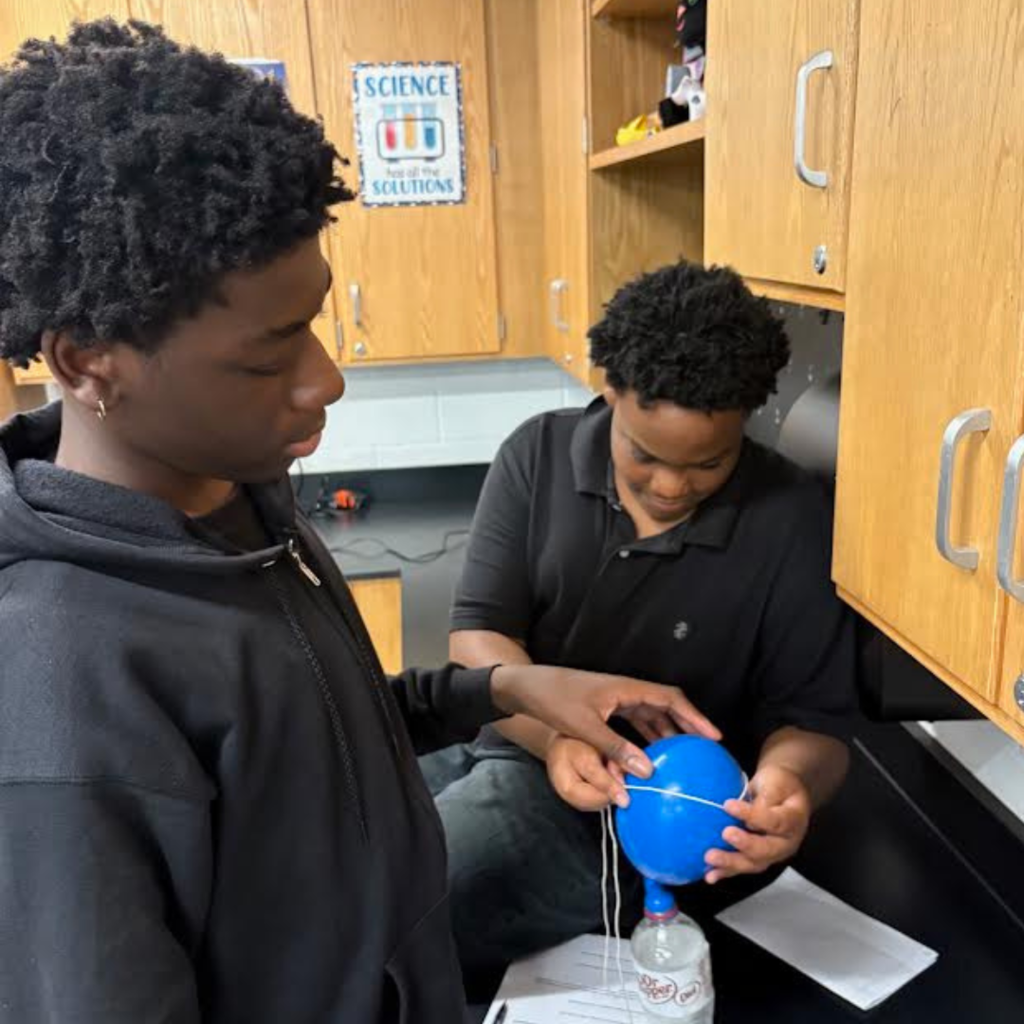 students conducting a science lab in the classroom