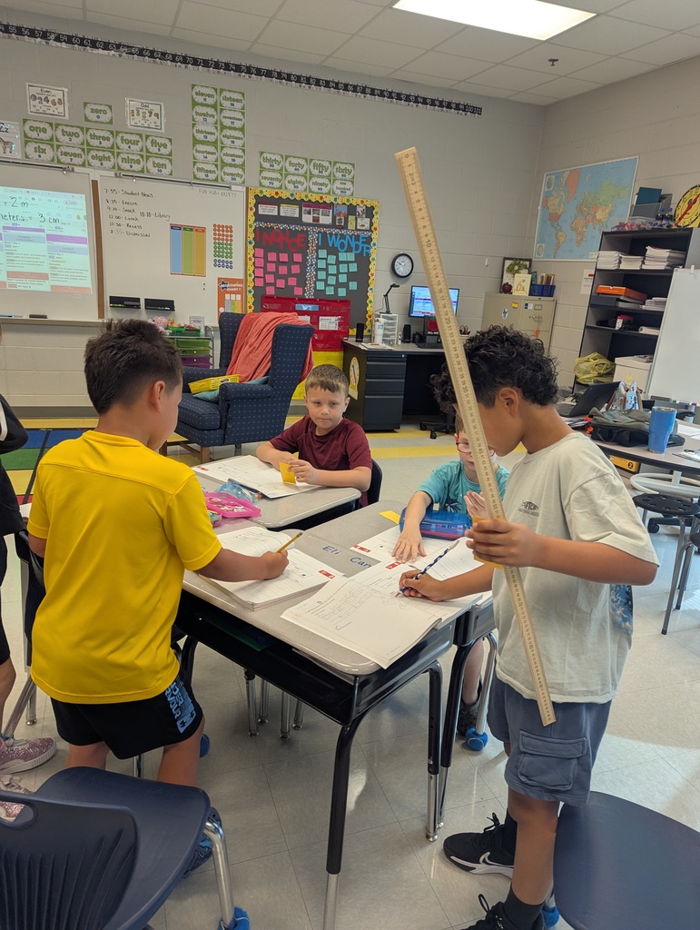 2nd graders learning to use the meter stick