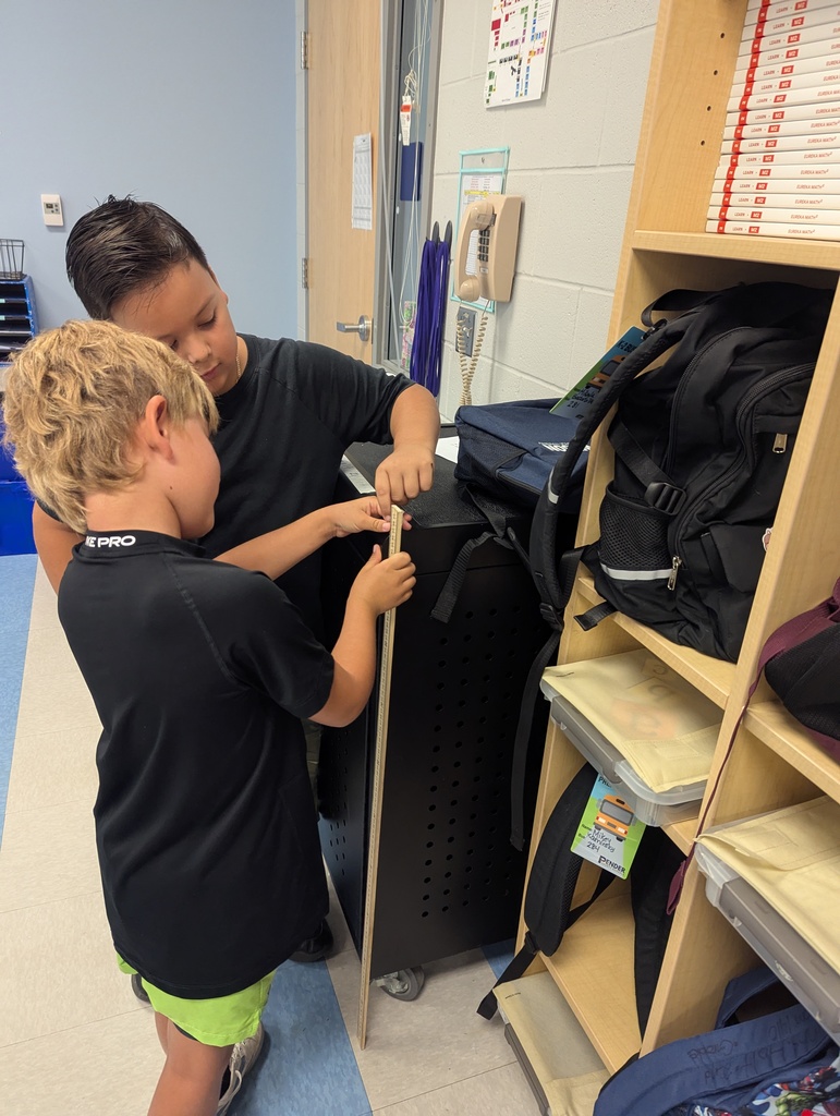 2nd graders learning to use the meter stick