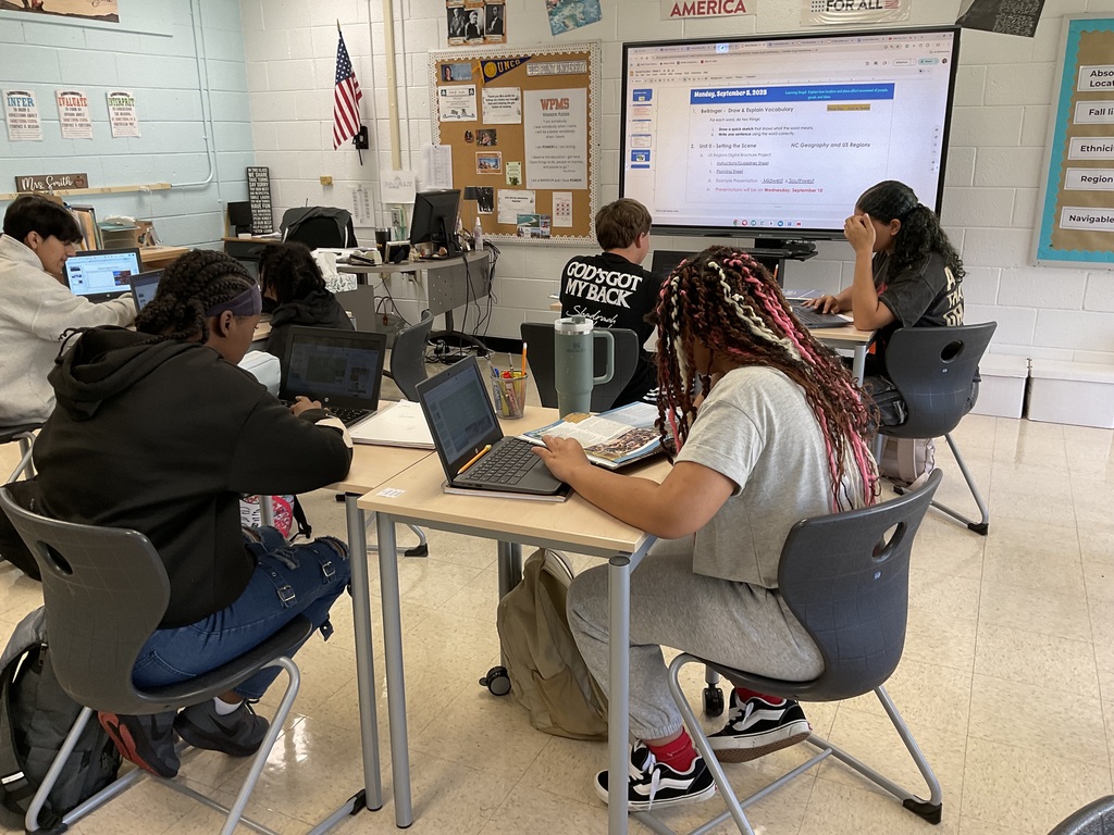 Students working on their digital US regional travel brochure