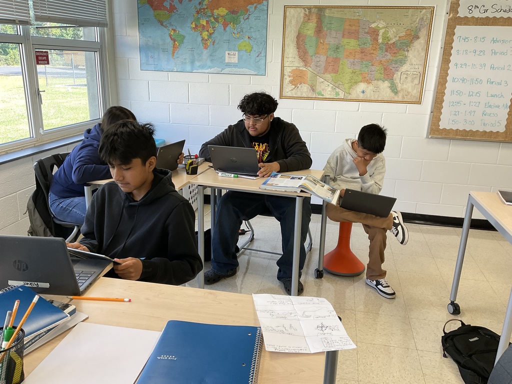 Students working on their digital US regional travel brochure